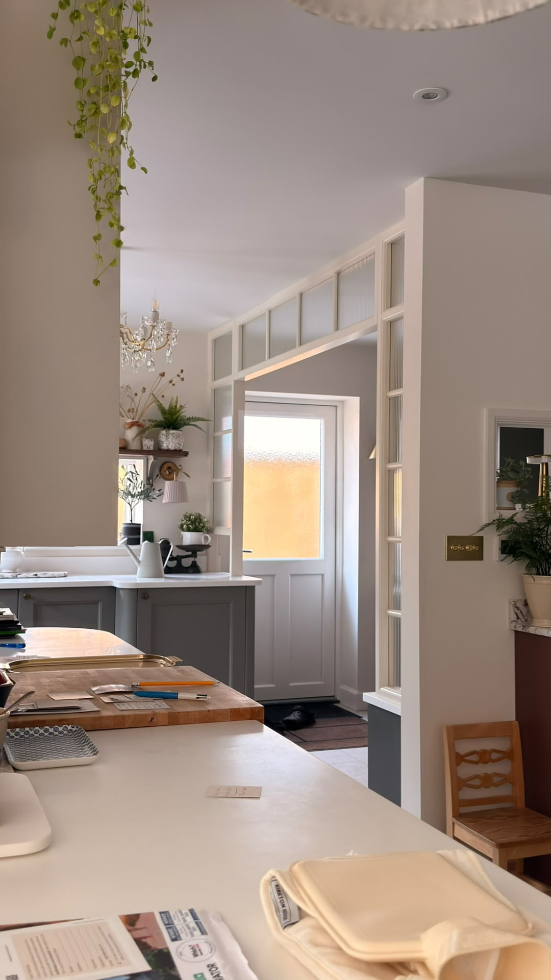 Bespoke glazed internal screen and door surround with reeded glass and painted panelling in a kitchen
