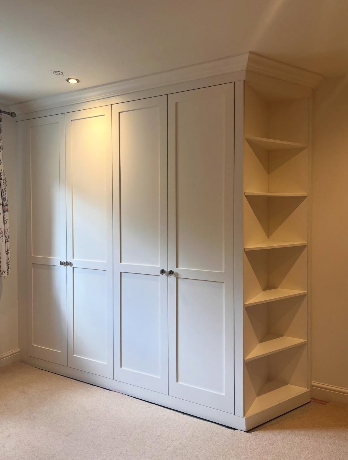 Large white panelled fitted wardrobe with open shelving bay, made to measure
