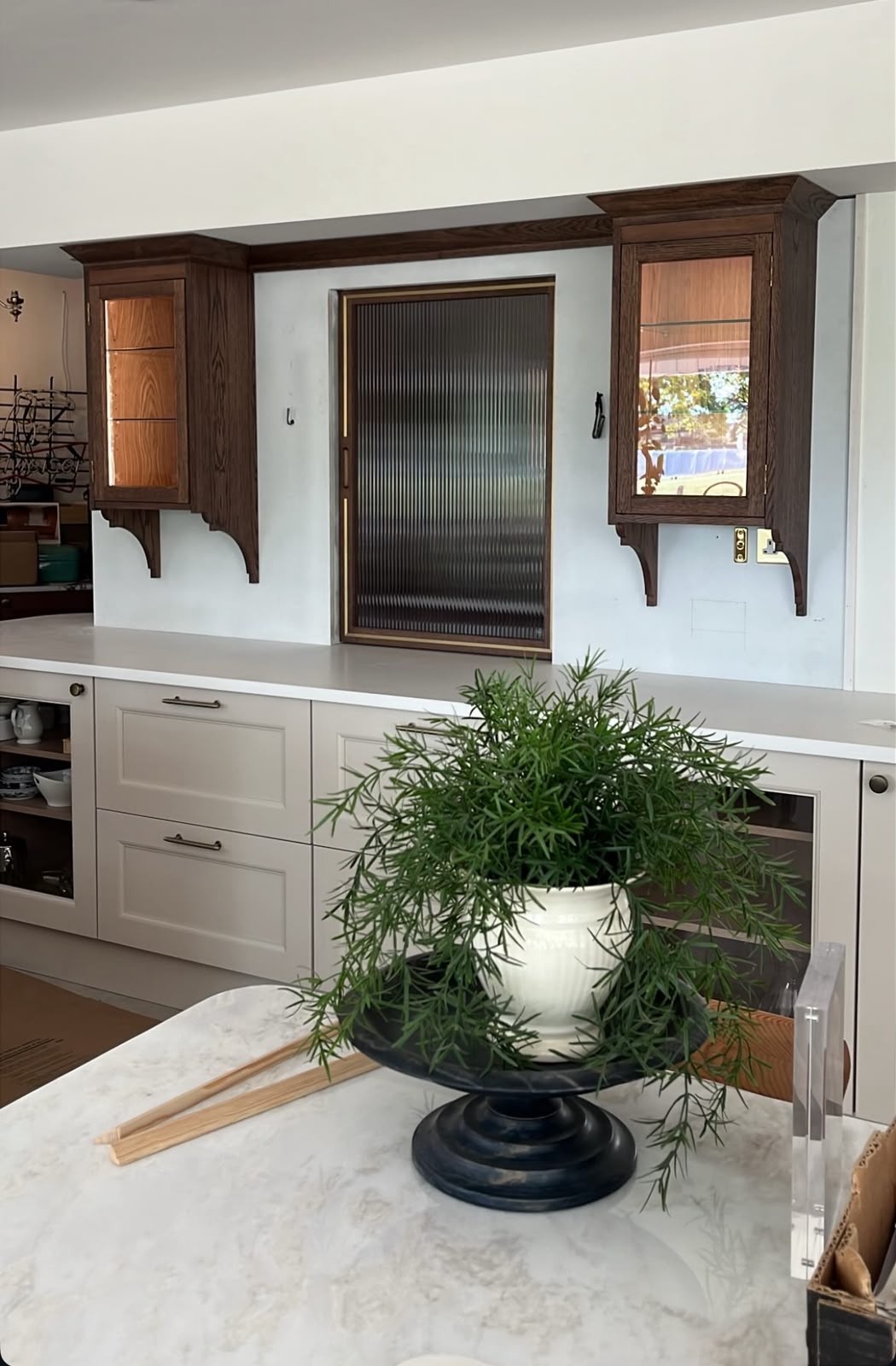 Hand-painted bespoke kitchen with walnut display cabinets, glass-fronted doors and a central island